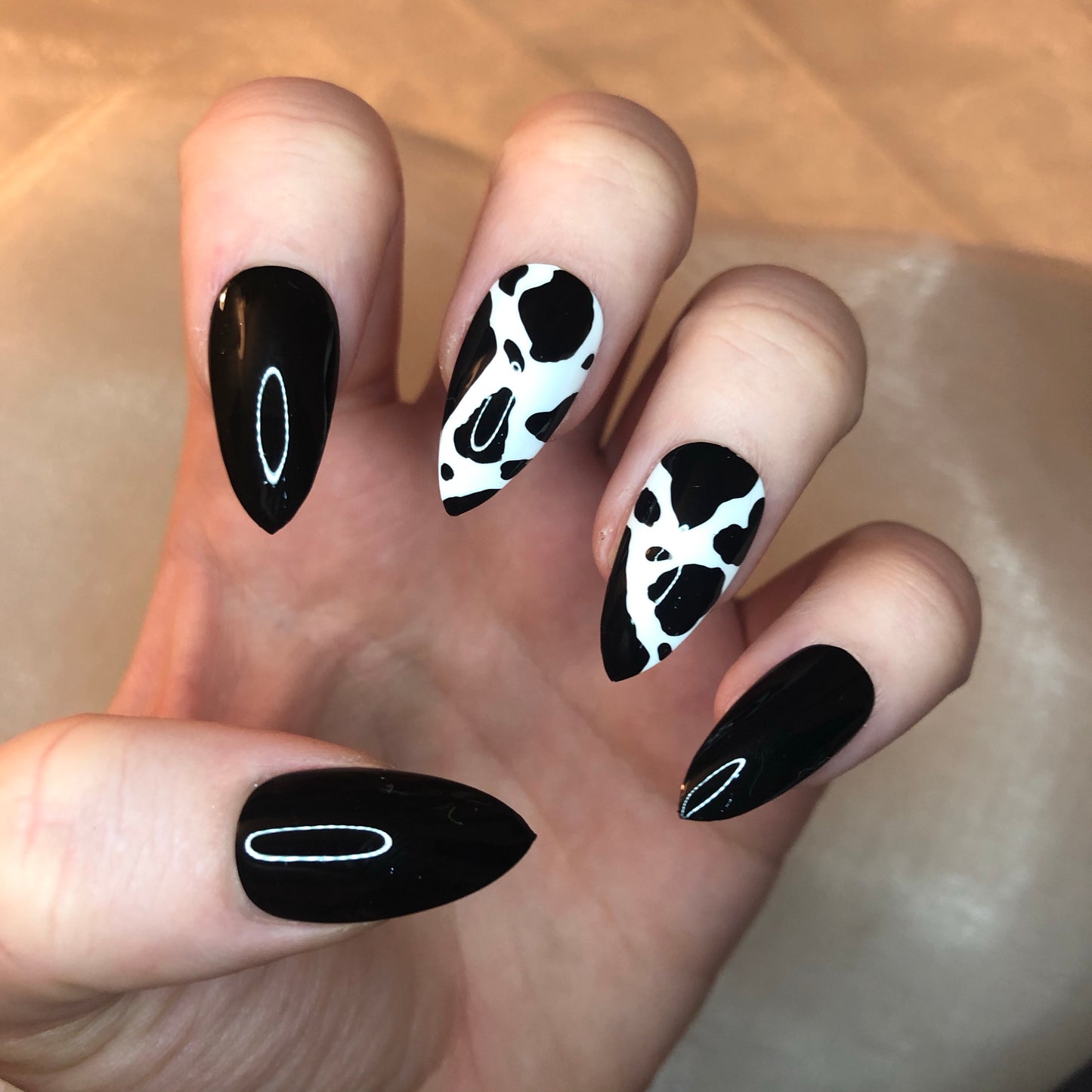 Cow Print and Black Stiletto Nails