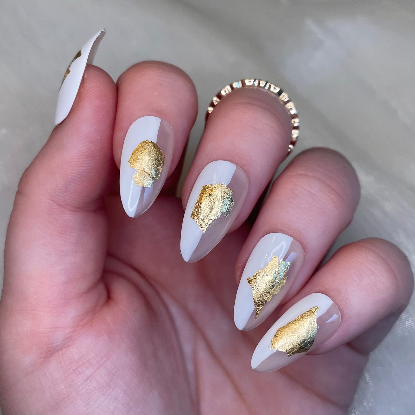 White and Sheer Nude Almond Nails with Gold Leaf Design
